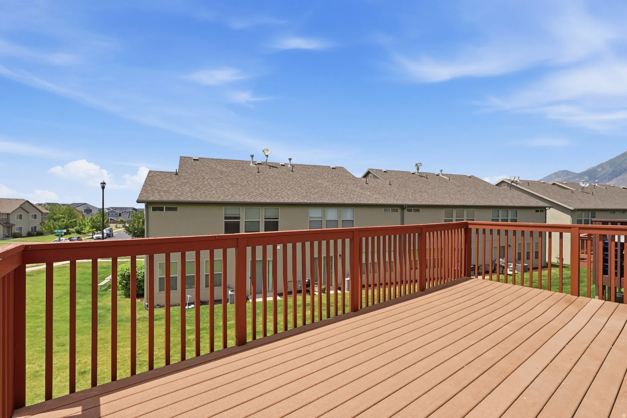 Spacious outdoor deck with composite wood-finish flooring and a wood railing system