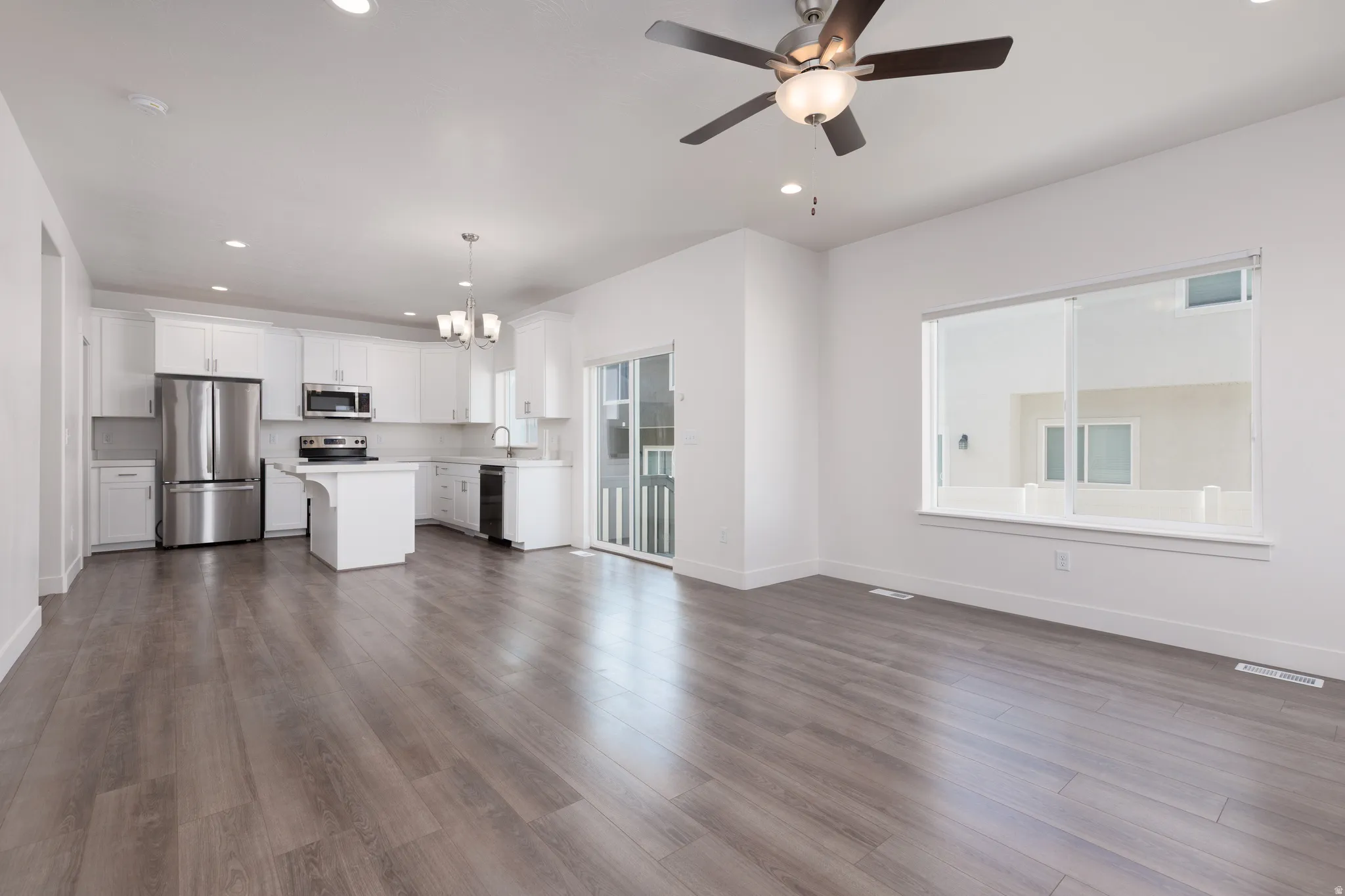 Open-concept living space with wood-finish flooring