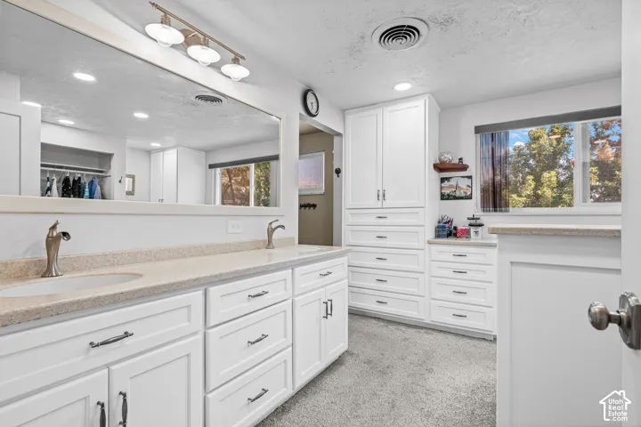 Dual vanity with undermount sinks and brushed nickel faucets, set in a light-toned countertop