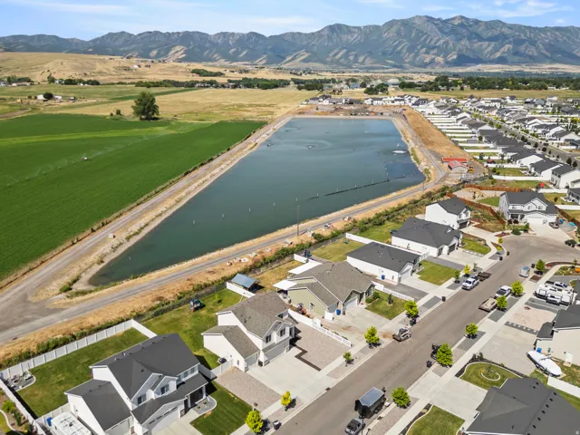 Expansive water feature bordered by agricultural fields and a residential development