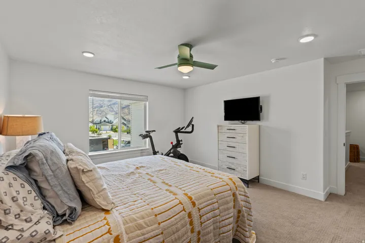 Room featuring white walls, recessed lighting, and a ceiling fan