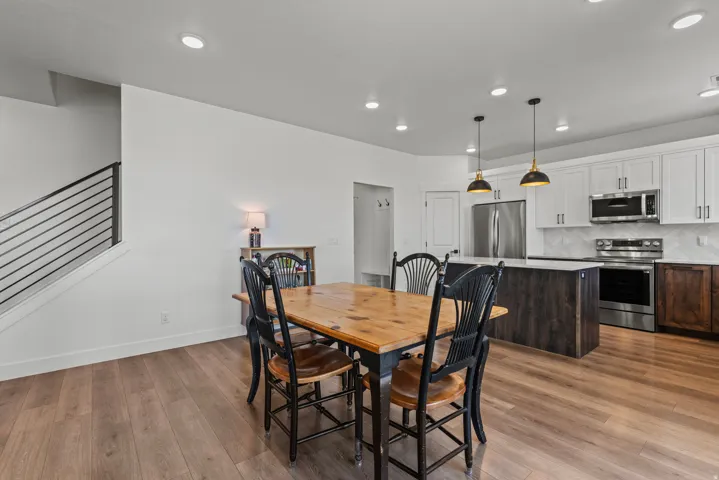 Open concept living area featuring wood-finish flooring