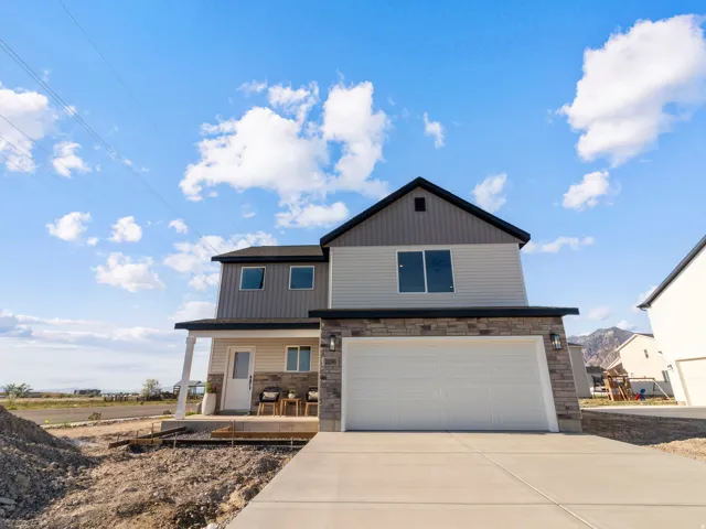 Contemporary exterior featuring a two-story design with a covered porch and an attached two-car garage