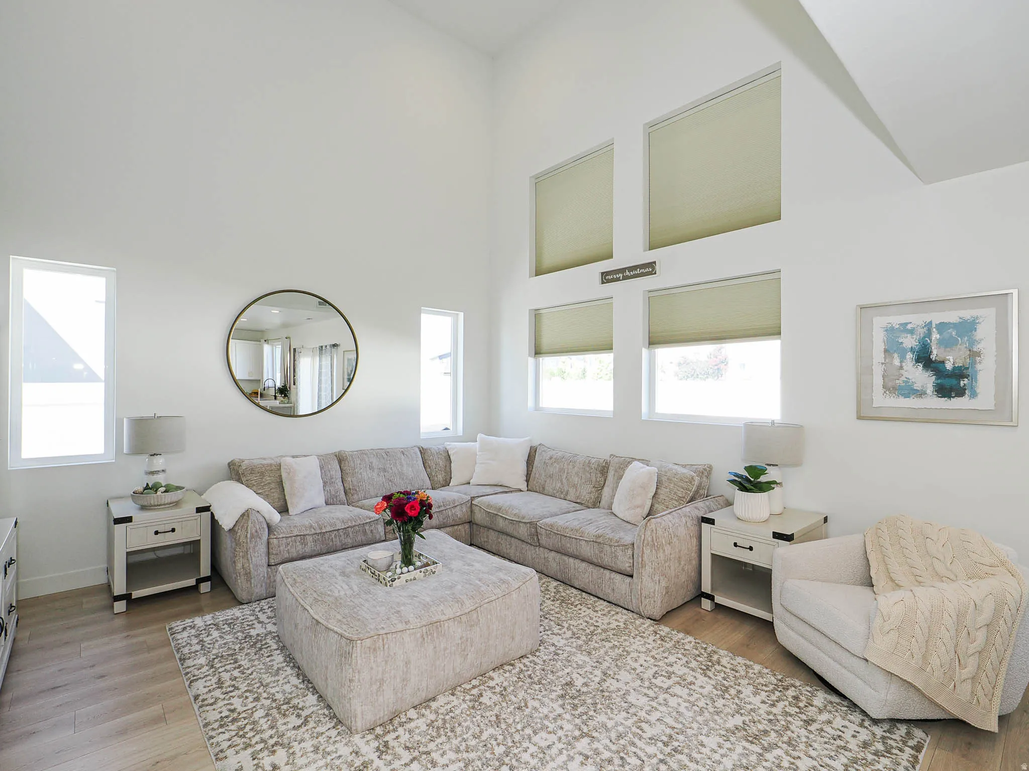 Vaulted ceiling living area featuring wood-finish flooring