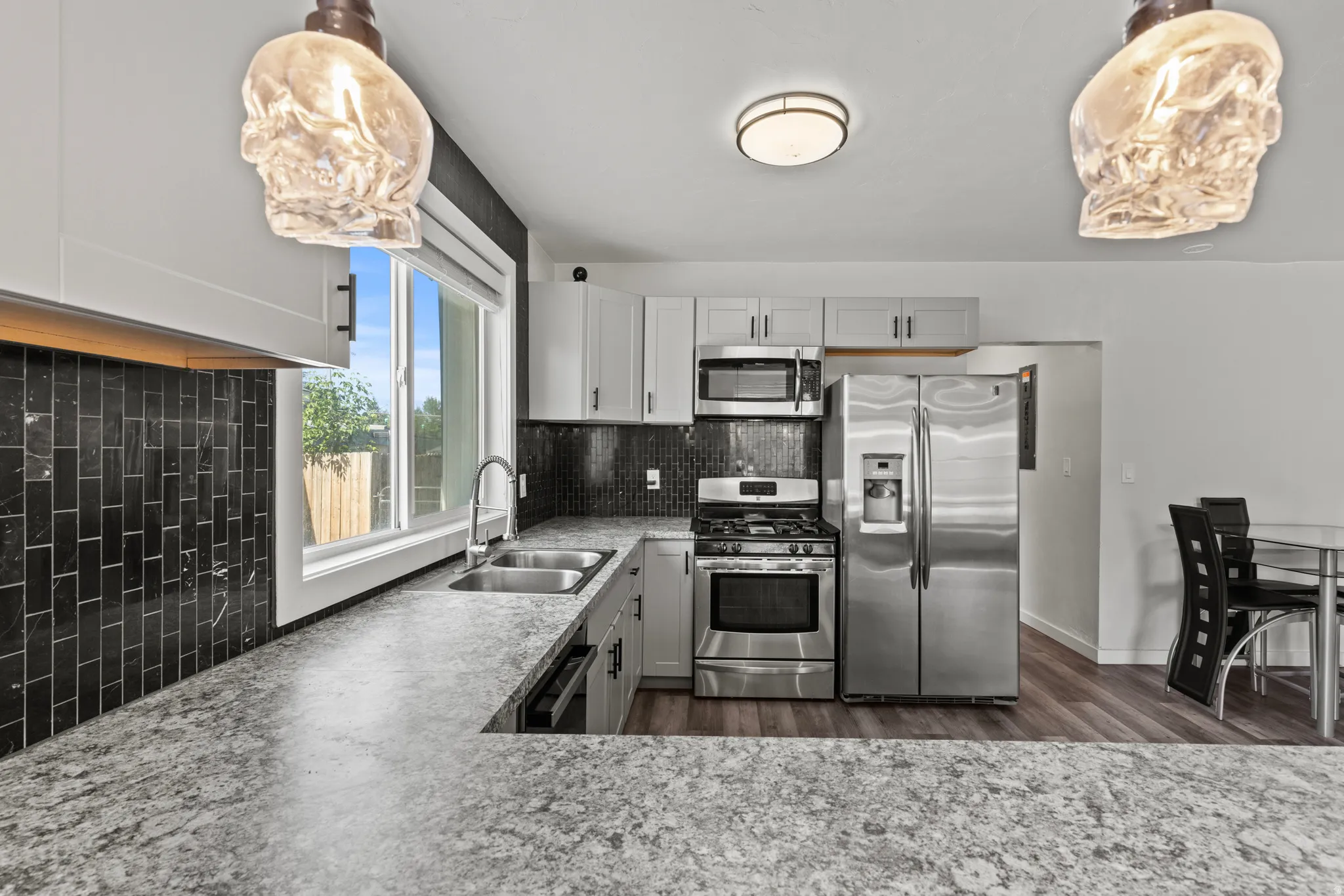 Modern kitchen featuring granite-look countertops and stainless steel appliances