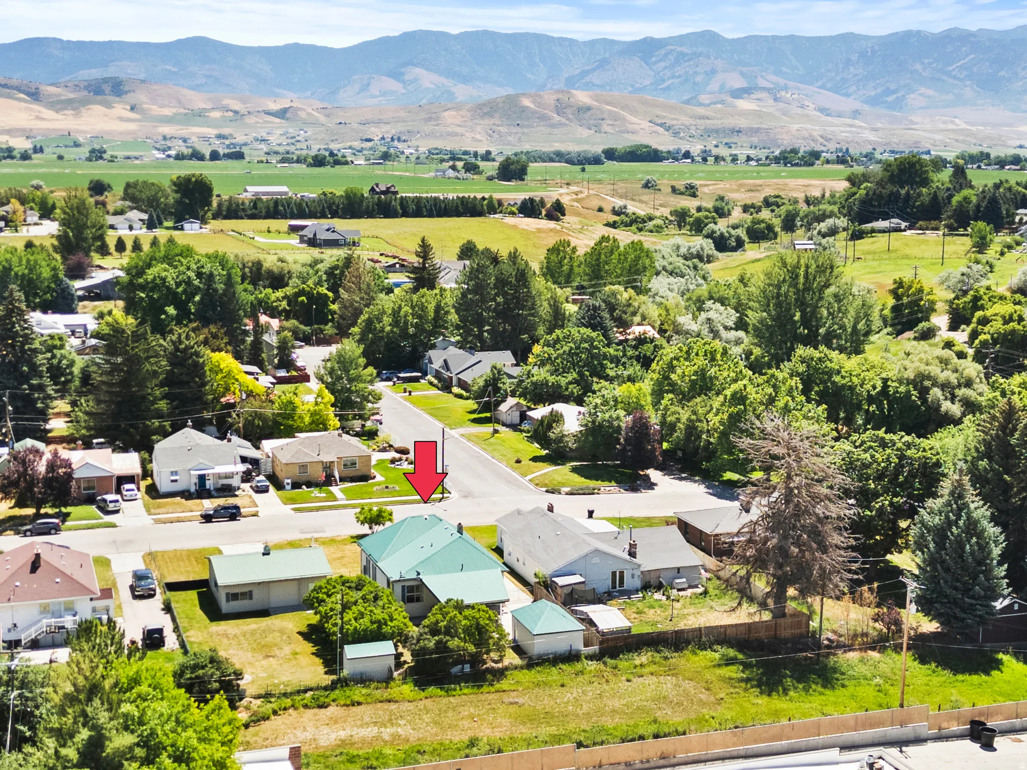 Aerial depiction of a residential neighborhood with distant mountains