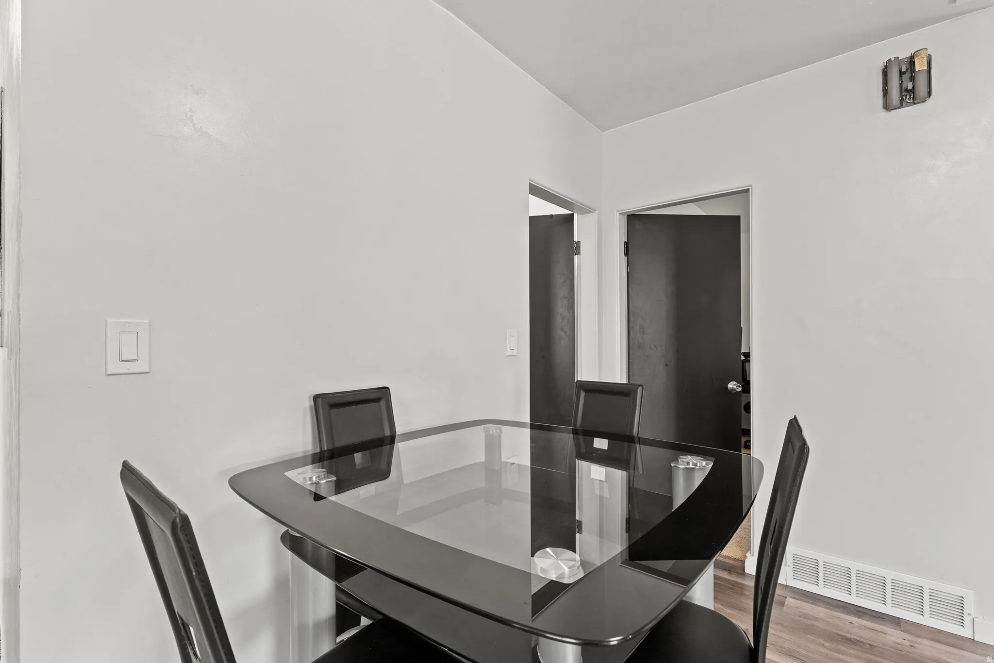 Dining area featuring light-toned walls and wood-finish flooring