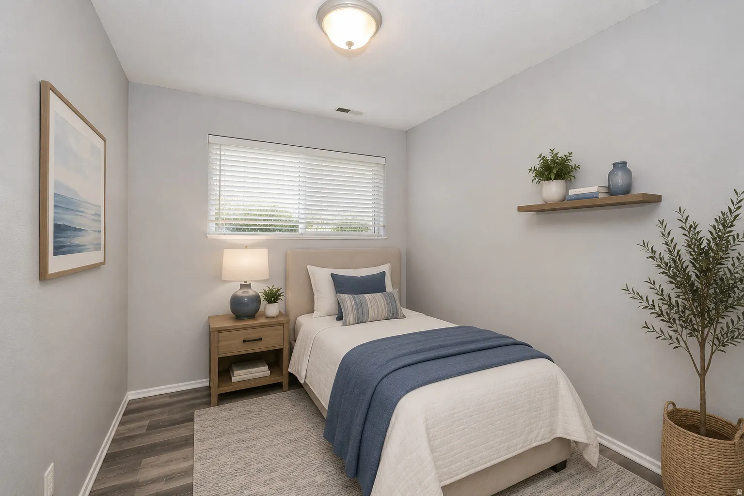 Bright room featuring wood-finish flooring and a single window with blinds