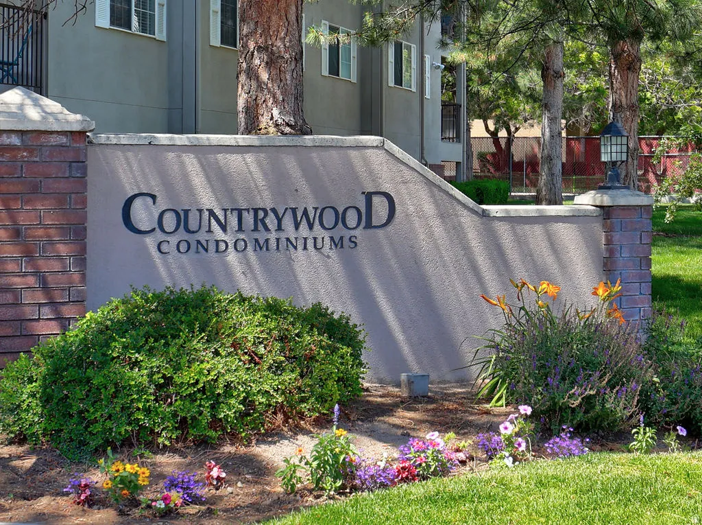 Community entry sign with brick pillars and a stucco finish