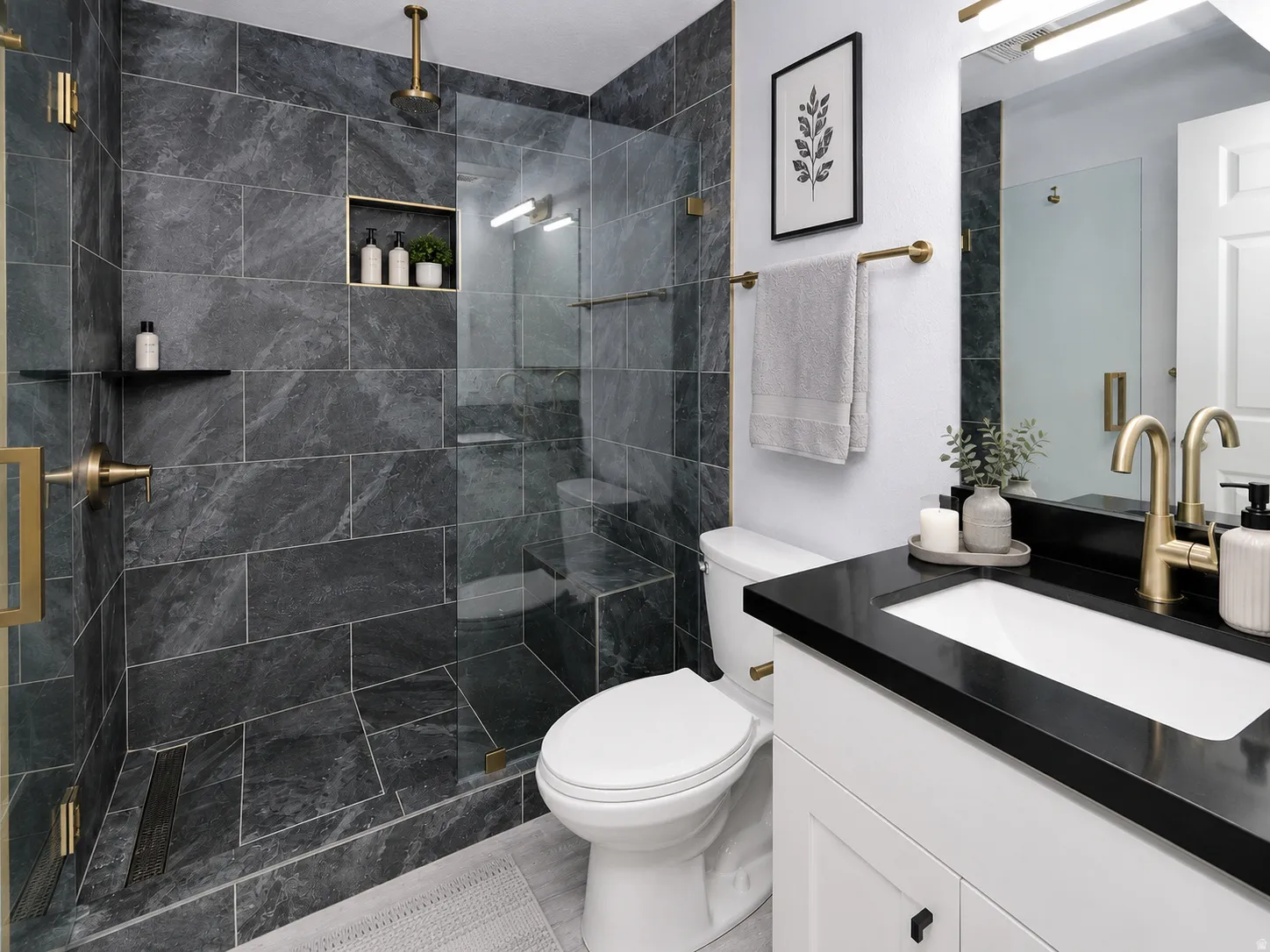 Bathroom featuring a large walk-in shower with dark stone-finish tiling, a built-in shower niche, and brass fixtures