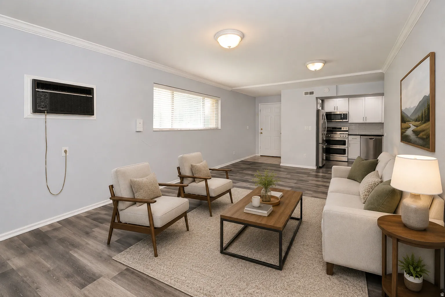 Open-concept living area featuring wood-finish flooring, crown molding, and recessed lighting