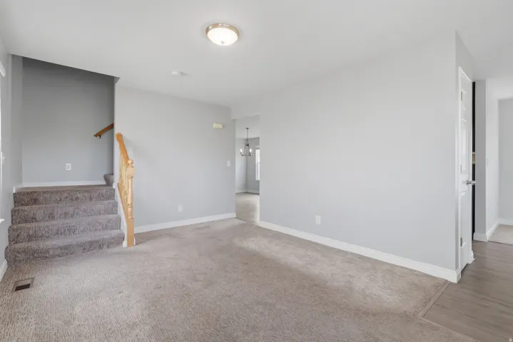 Spacious upper-level room featuring neutral wall finishes, wood-finish flooring, recessed lighting, and direct access to a full bathroom