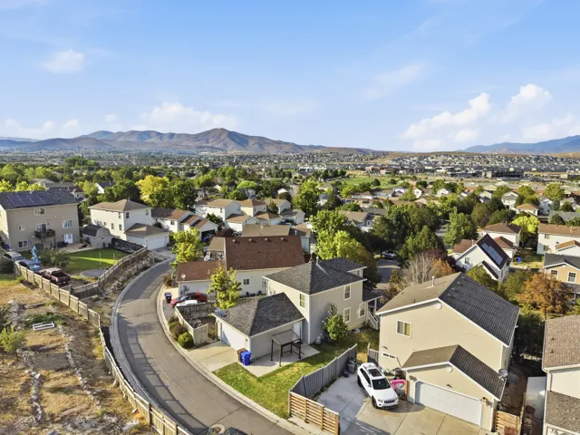 Aerial neighborhood view showcasing this residence situated on a curved street within an established community