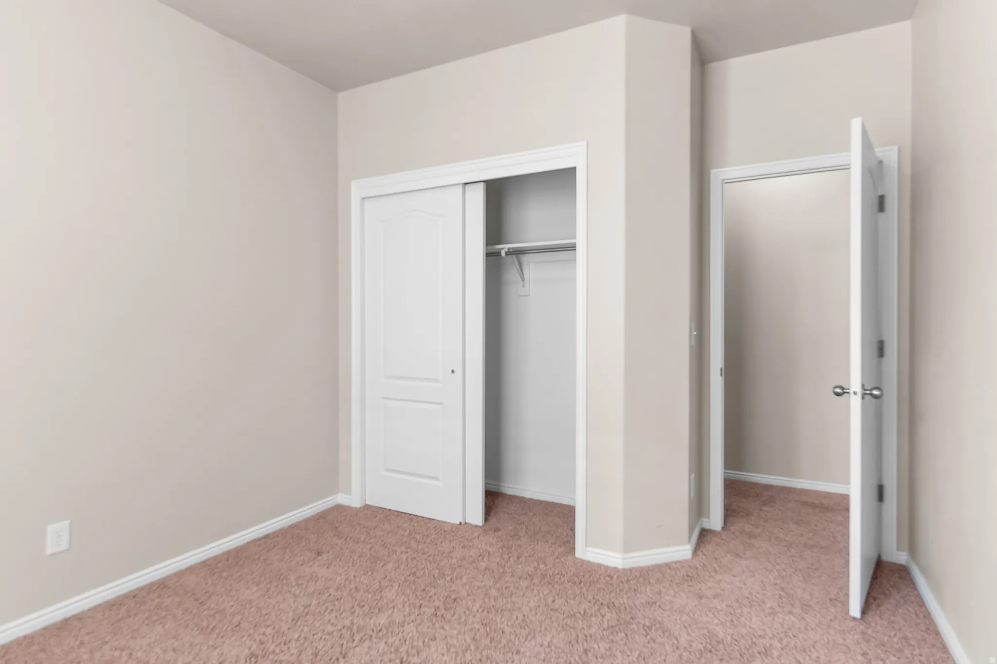 Neutral-toned walls complement plush carpeting