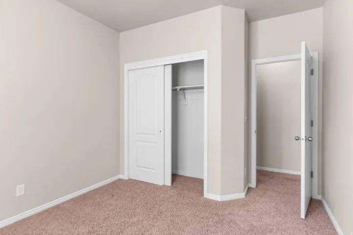 Neutral-toned walls complement plush carpeting