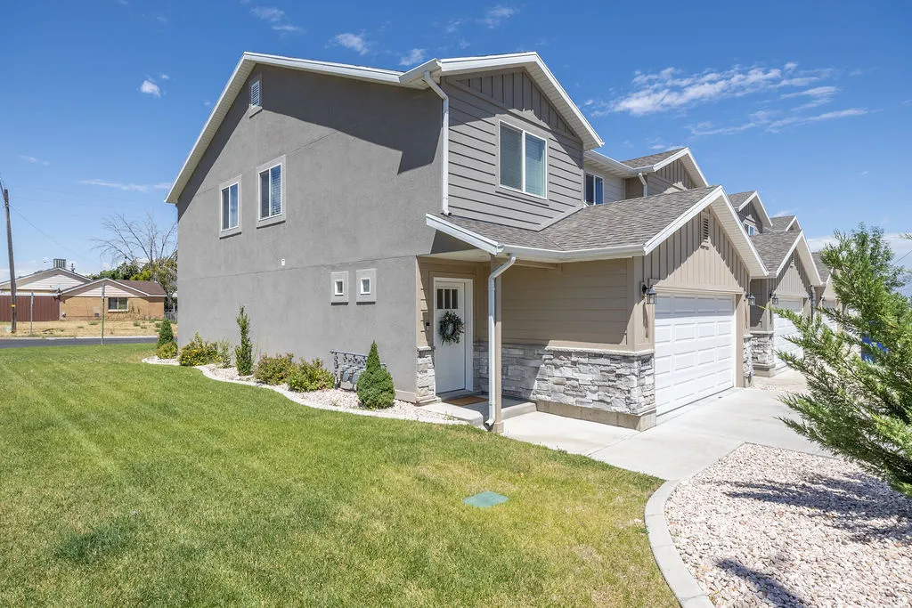 Gray stucco and siding exterior with white trim