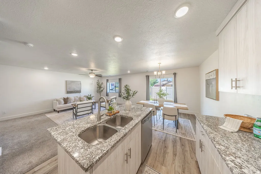 Kitchen island, lots of counter top space.  Open-concept interior.  STAINLESS STEEL appliances will STAY.