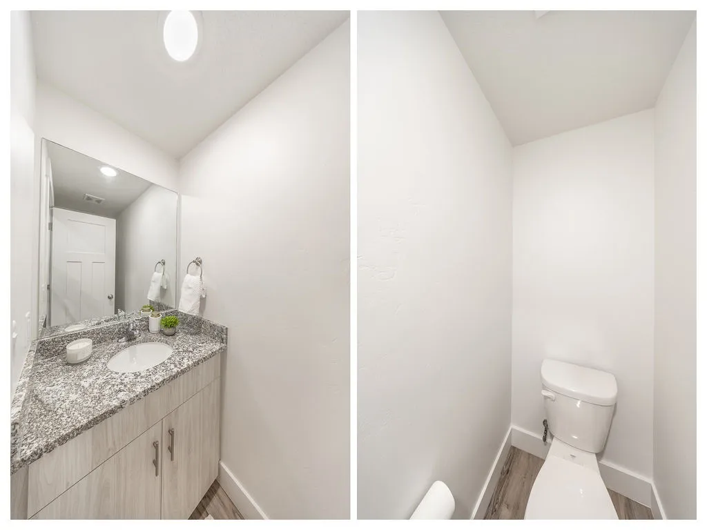 Powder room featuring a single vanity with a granite-style countertop, undermount sink, and light wood-finish cabinetry