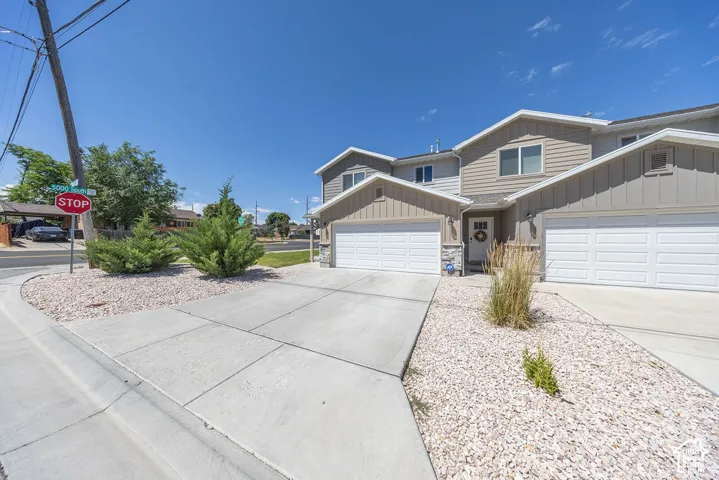 Contemporary multi-level exterior.  Attached garage.  Concrete driveway.  Low-maintenance landscaping featuring decorative rock and established shrubs.
