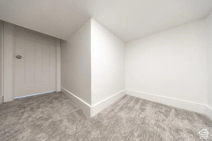 Neutral-toned wall-to-wall carpeting and crisp white walls