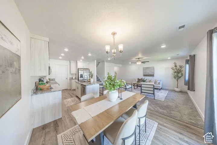 Open-concept living area with a dining space, kitchen, and living room.  Lots of lighting.  Lots of NATURAL LIGHT.