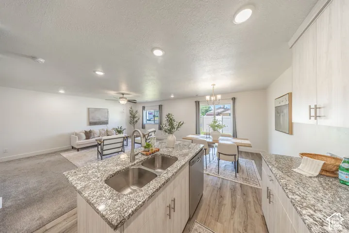 Kitchen island, lots of counter top space.  Open-concept interior.  STAINLESS STEEL appliances will STAY.