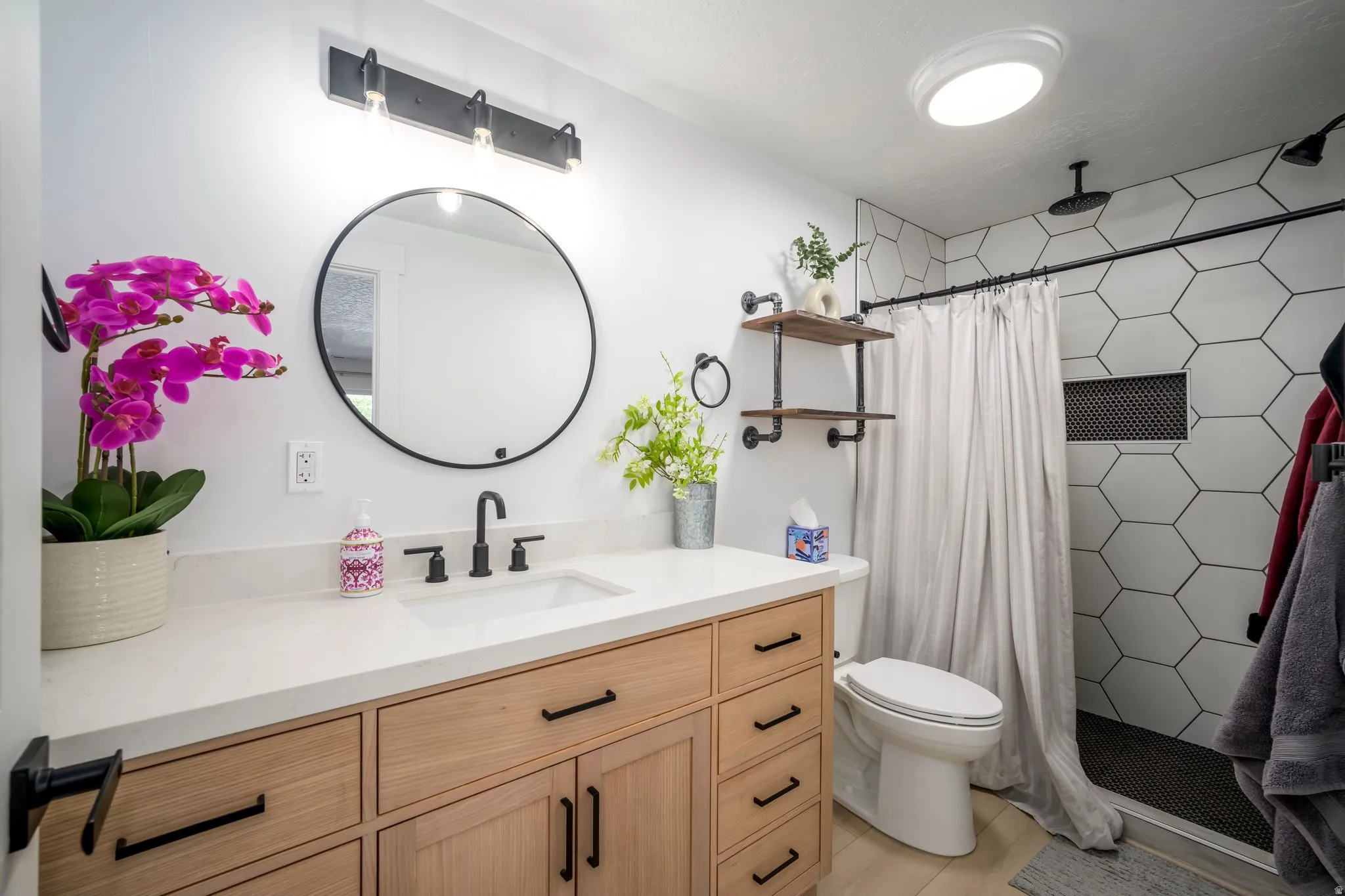 Bathroom featuring a wood-finish vanity with ample storage