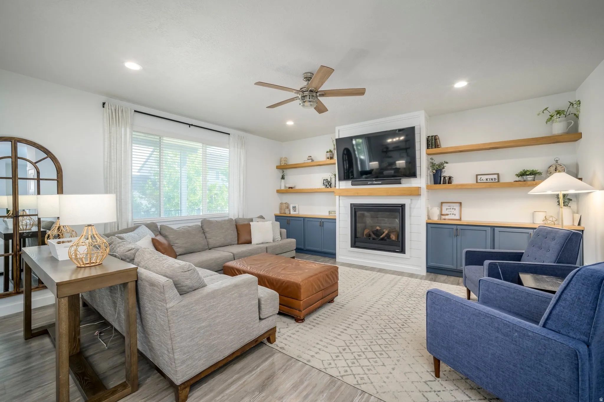 Spacious living area featuring wood-finish flooring, recessed lighting, and a ceiling fan