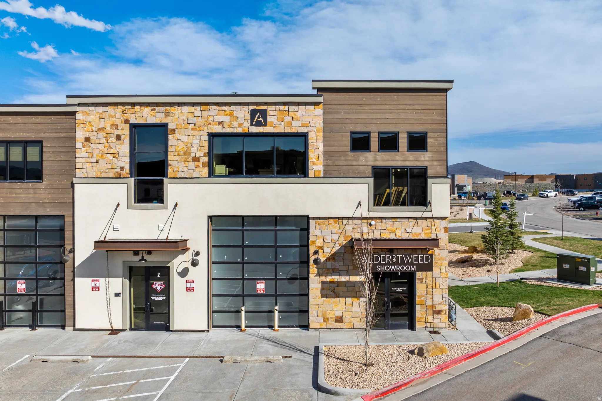 Multi-level commercial facade featuring varied stone and wood-look siding