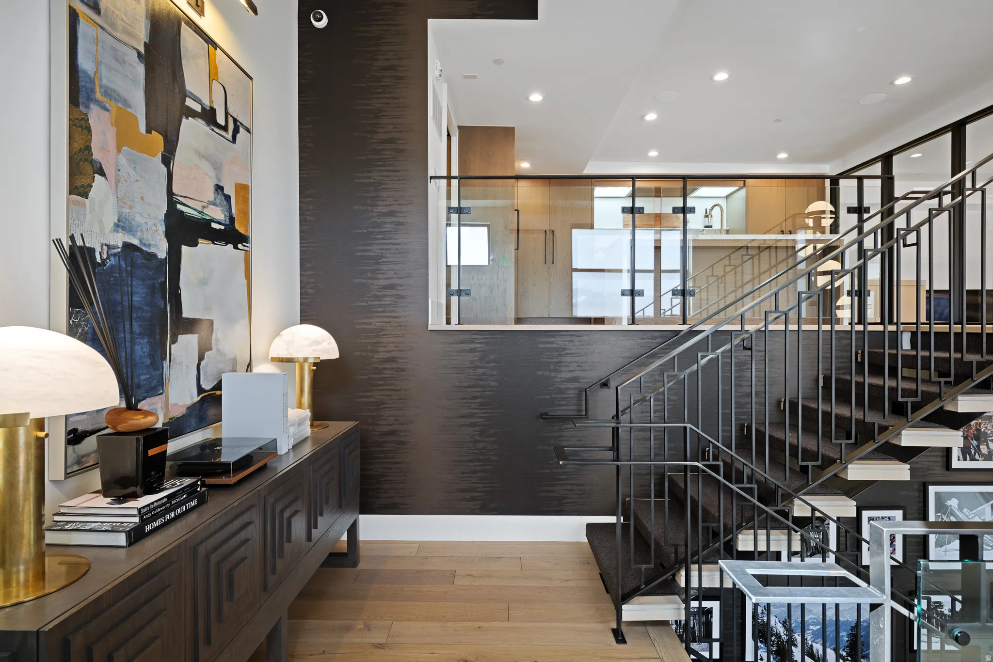 Modern staircase with black metal railings and light wood-finish treads