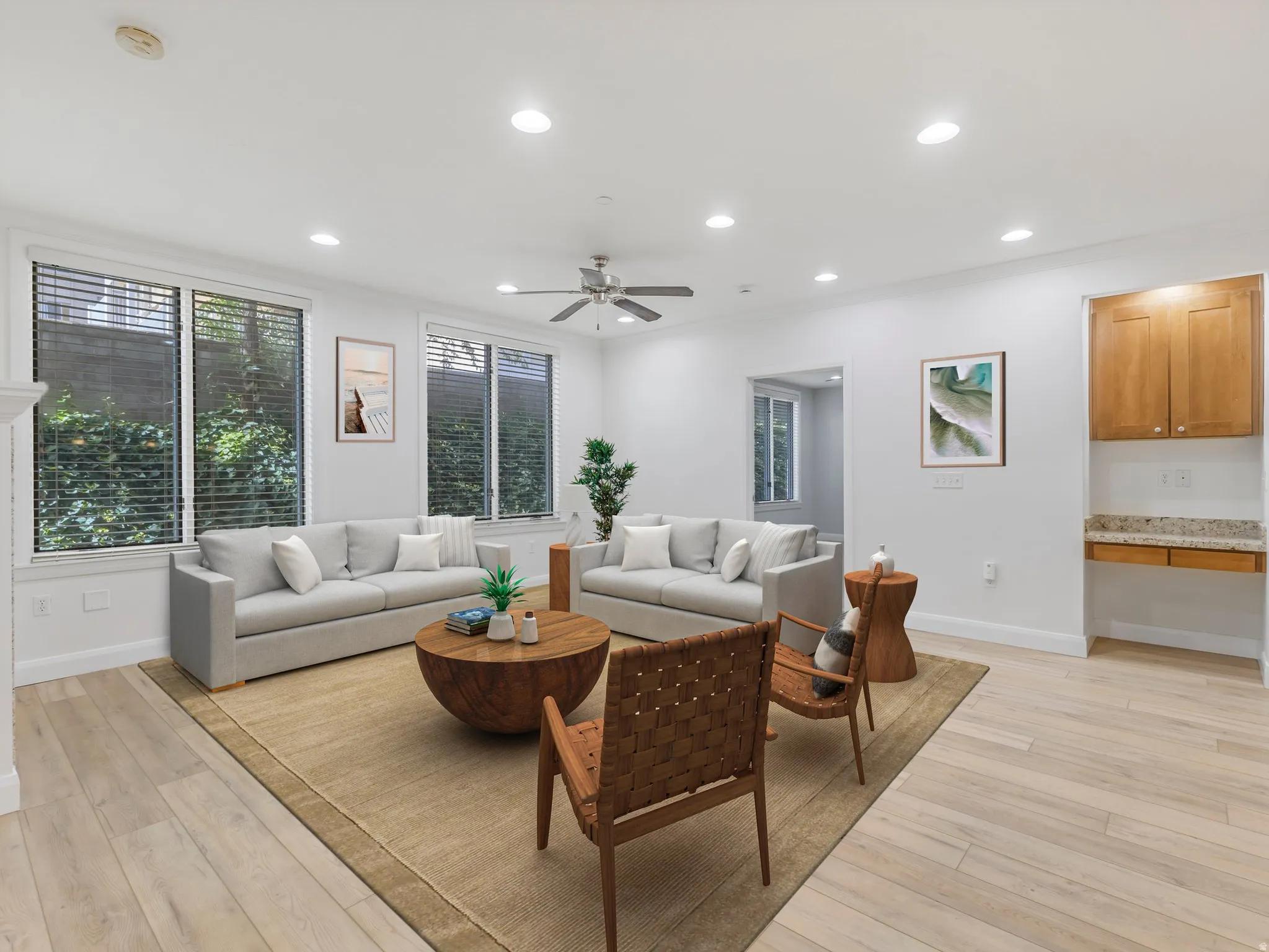 Bright living space featuring wood-finish flooring, multiple windows with blinds, recessed lighting, and a ceiling fan