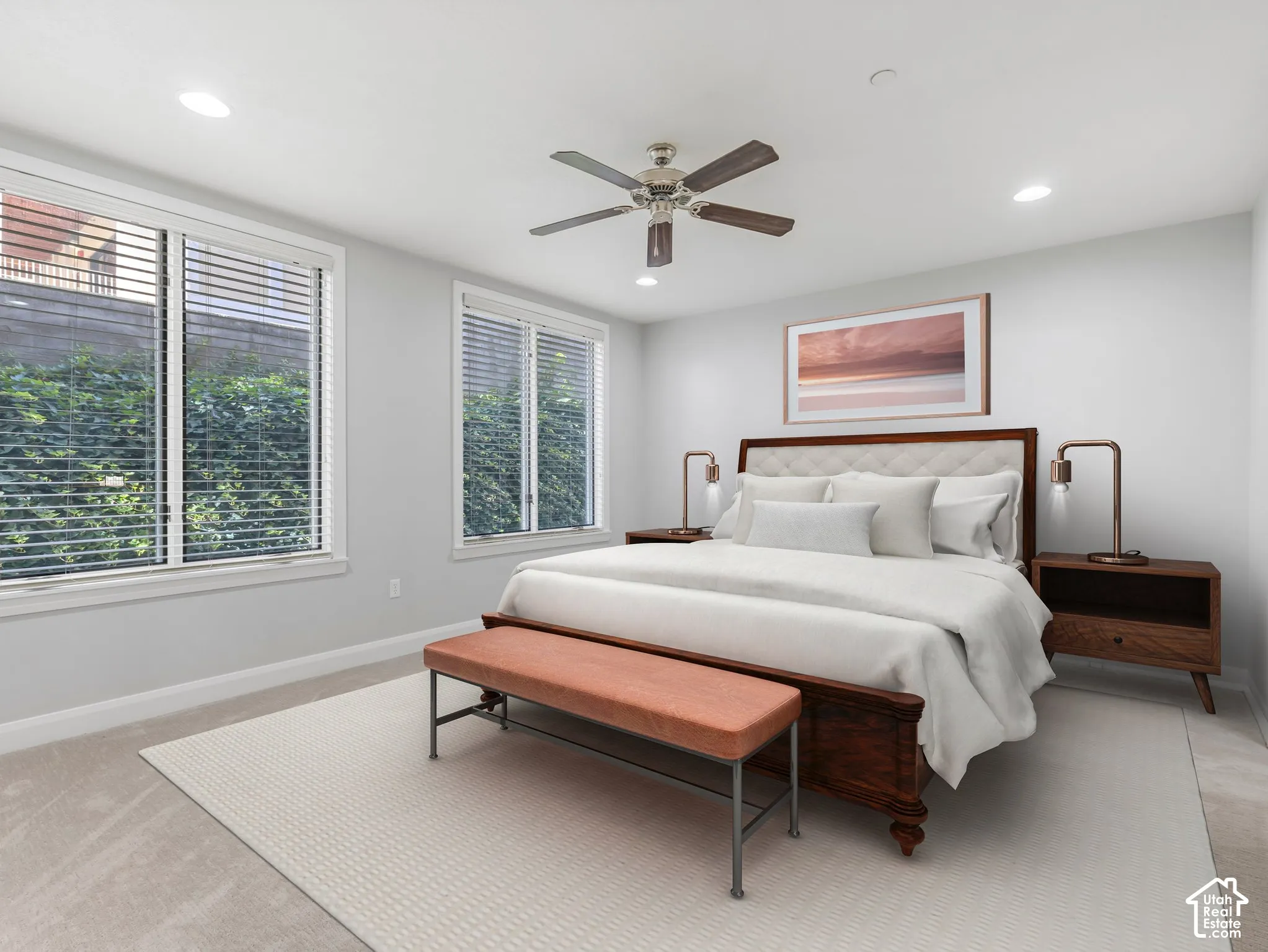 Spacious room featuring two large windows with blinds, recessed lighting, and a ceiling fan