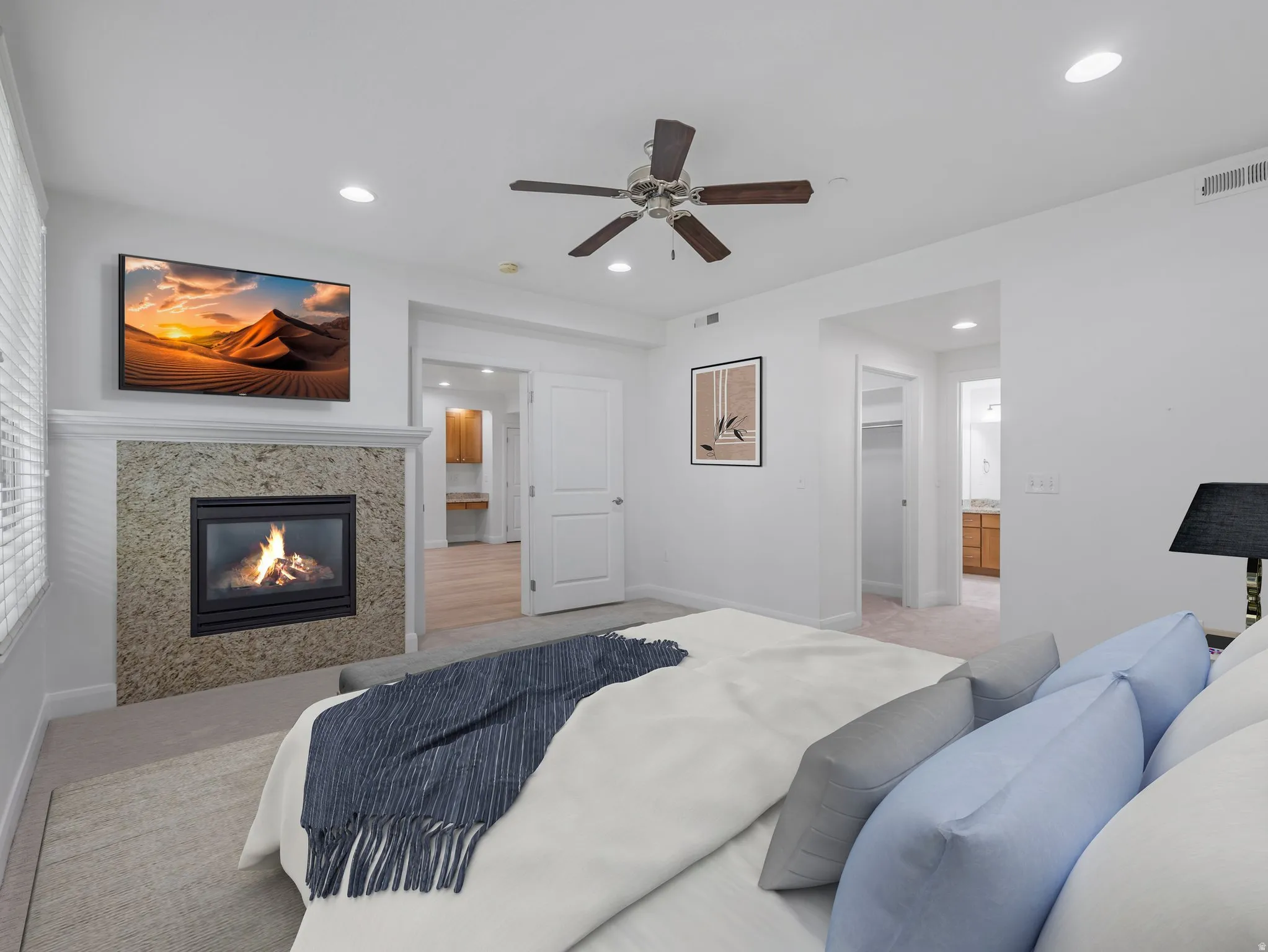Bedroom featuring a built-in fireplace with a stone surround and mantel