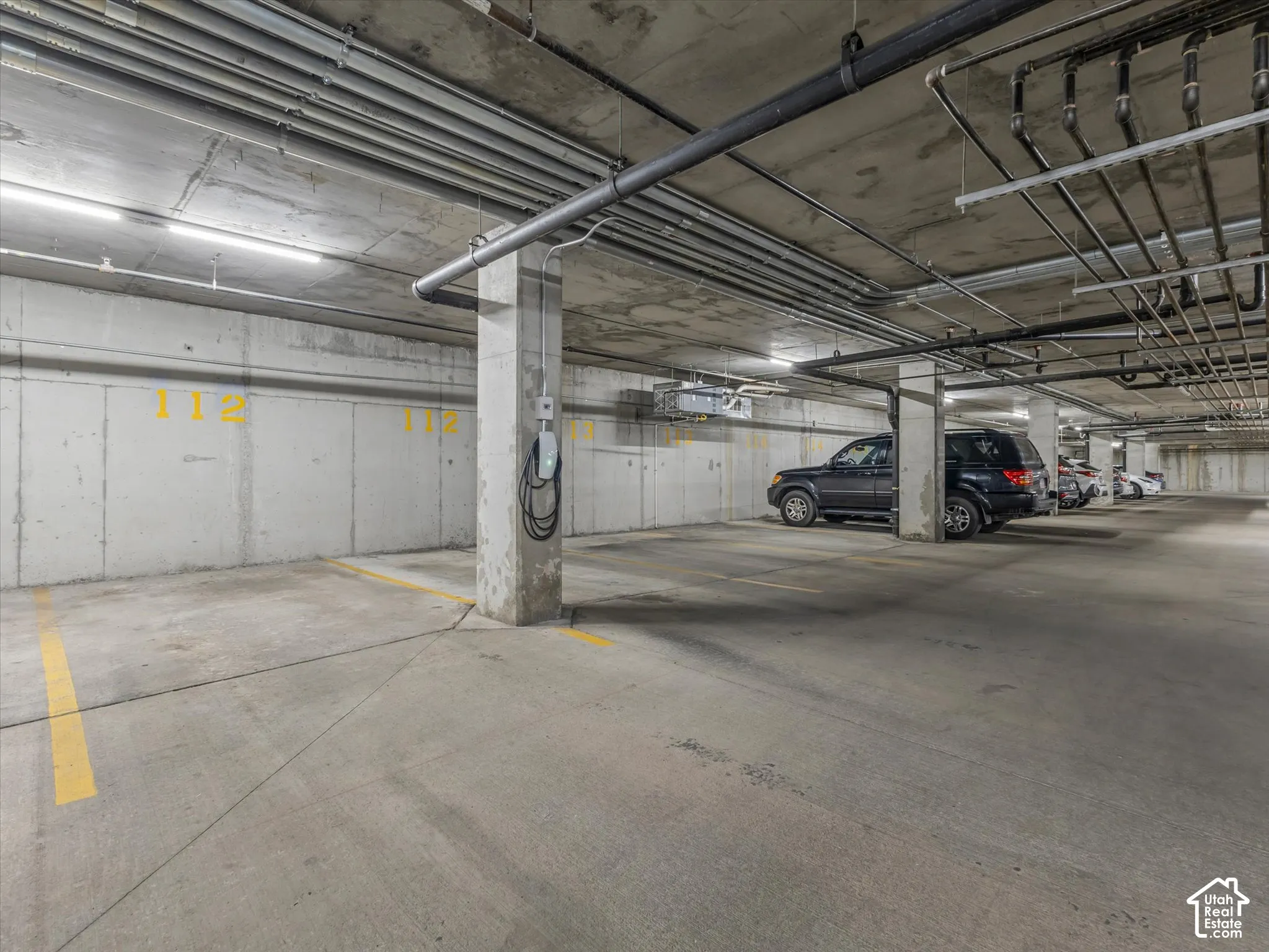 Concrete parking garage with dedicated parking space and electric vehicle charging station