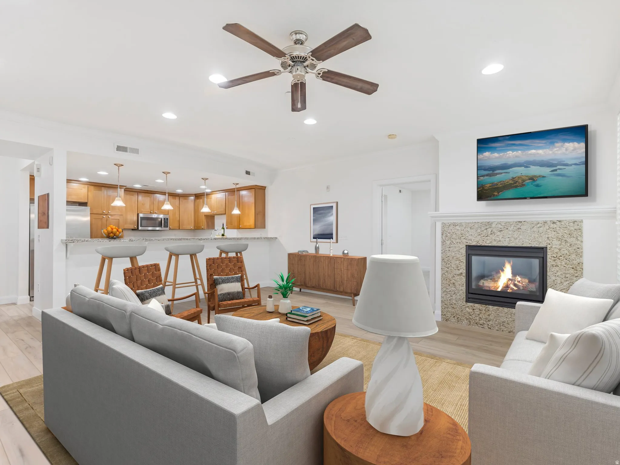 Living area featuring a fireplace with a stone surround and a white mantel