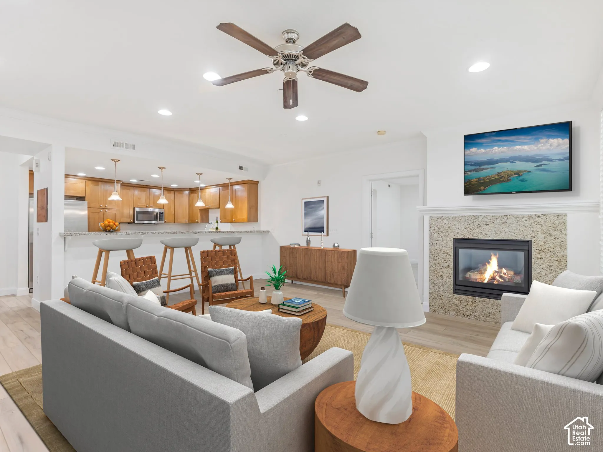 Living area featuring a fireplace with a stone surround and a white mantel