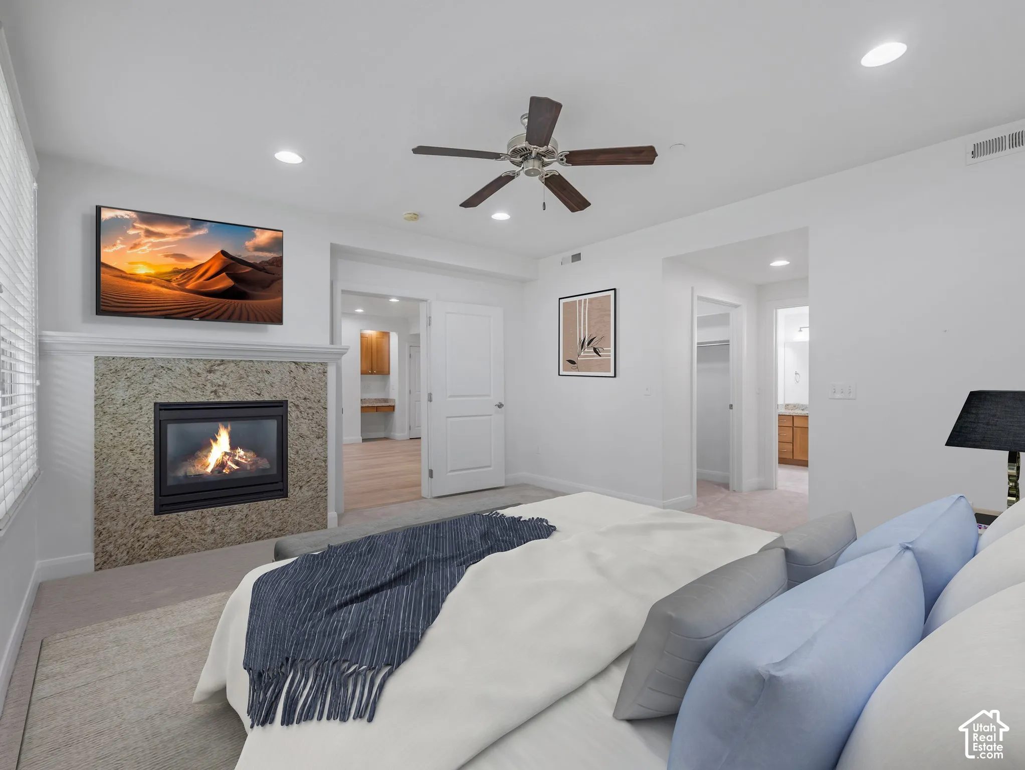 Bedroom featuring a built-in fireplace with a stone surround and mantel