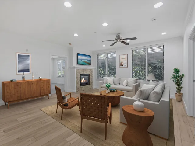 Spacious living area featuring light wood-finish flooring, recessed lighting, and a ceiling fan