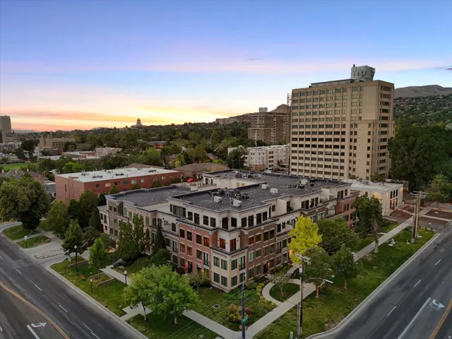 Modern multi-story building featuring varied facade materials including brick and light-colored panels