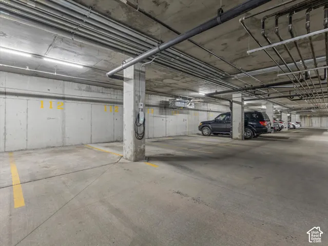 Concrete parking garage with dedicated parking space and electric vehicle charging station