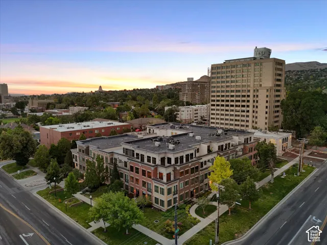 Modern multi-story building featuring varied facade materials including brick and light-colored panels