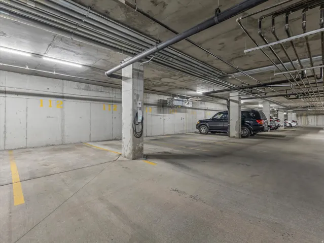 Concrete parking garage with dedicated parking space and electric vehicle charging station