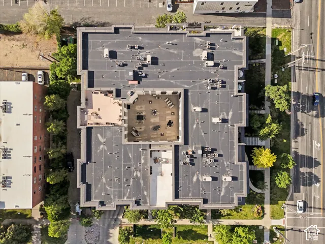 Multi-story building featuring a flat roofline, an interior courtyard, and multiple rooftop patio areas