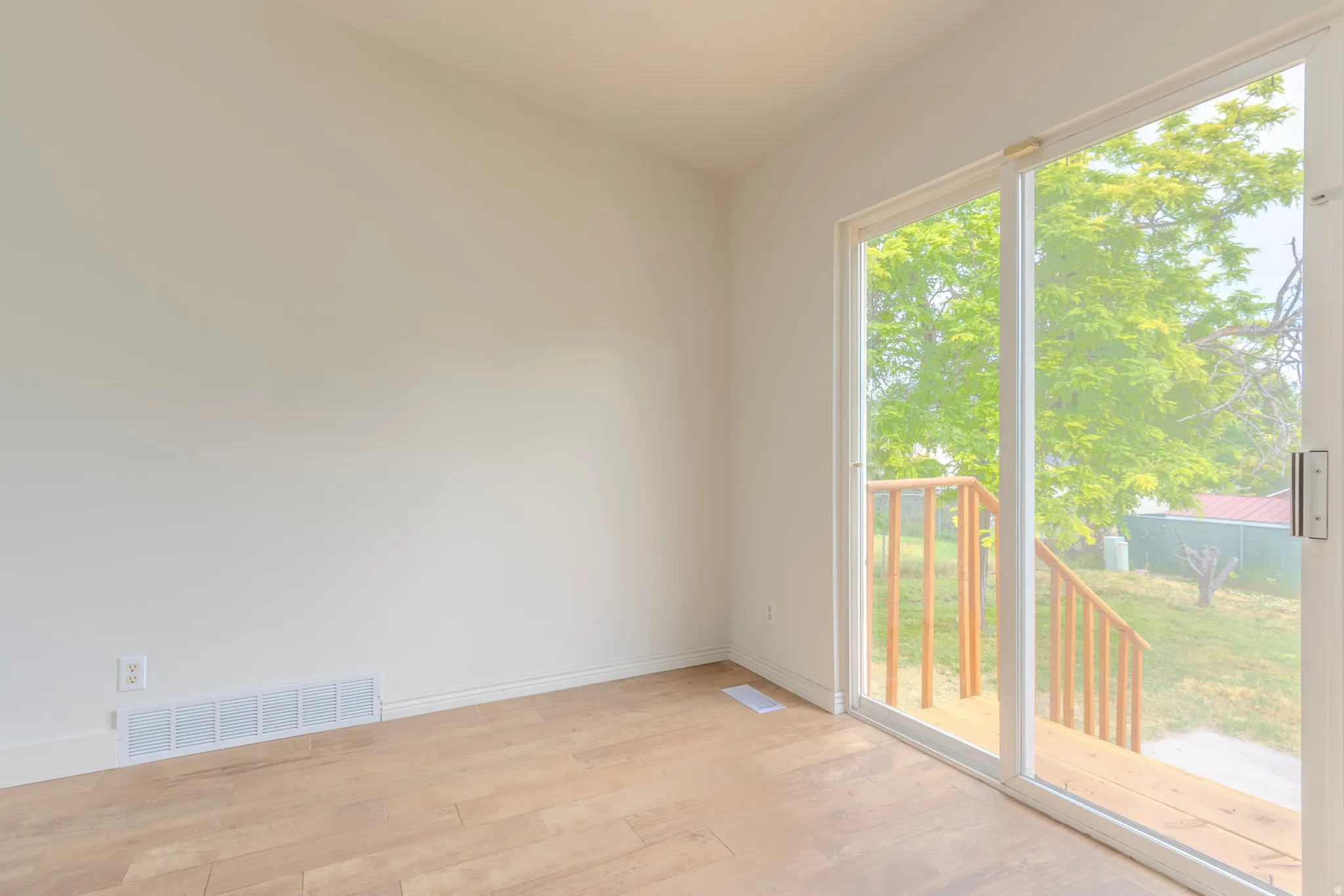 Bright interior space featuring wood-finish flooring, white walls, and white trim