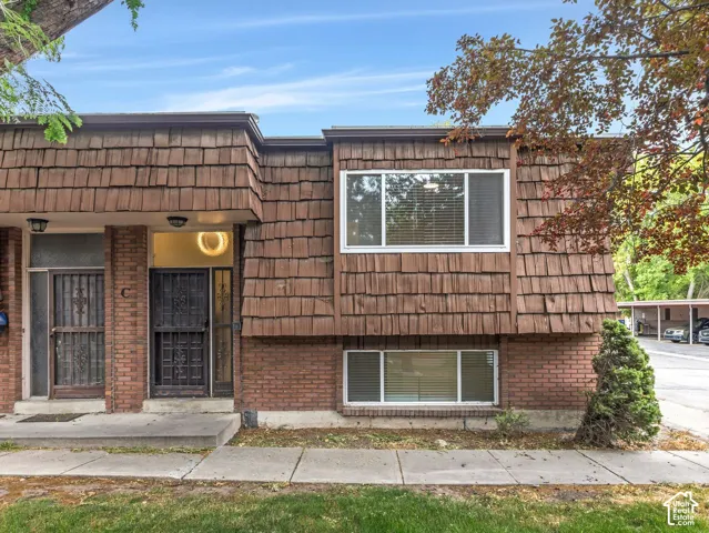 Brown shingle siding exterior with brick accents