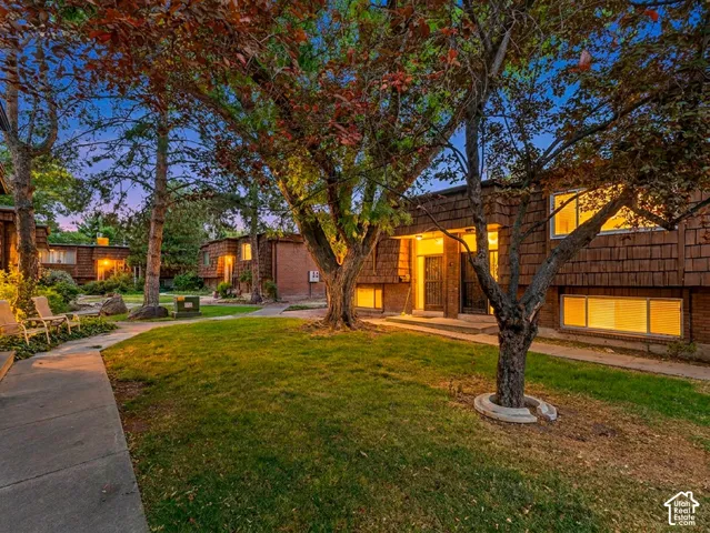 Exterior features include brick and cedar-shake siding, multiple windows, and a prominent entry