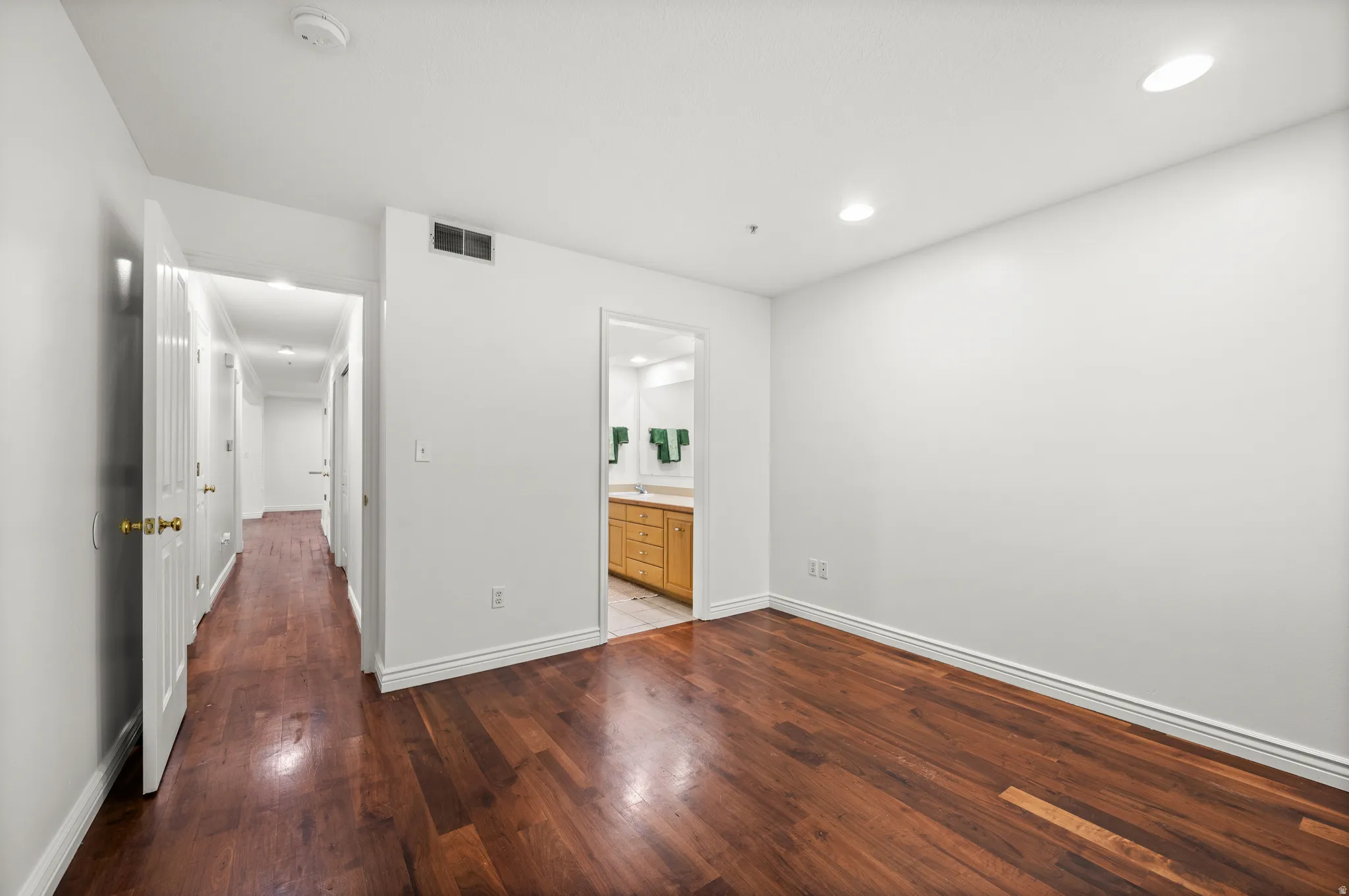 Hardwood flooring throughout, recessed lighting, and a neutral color palette