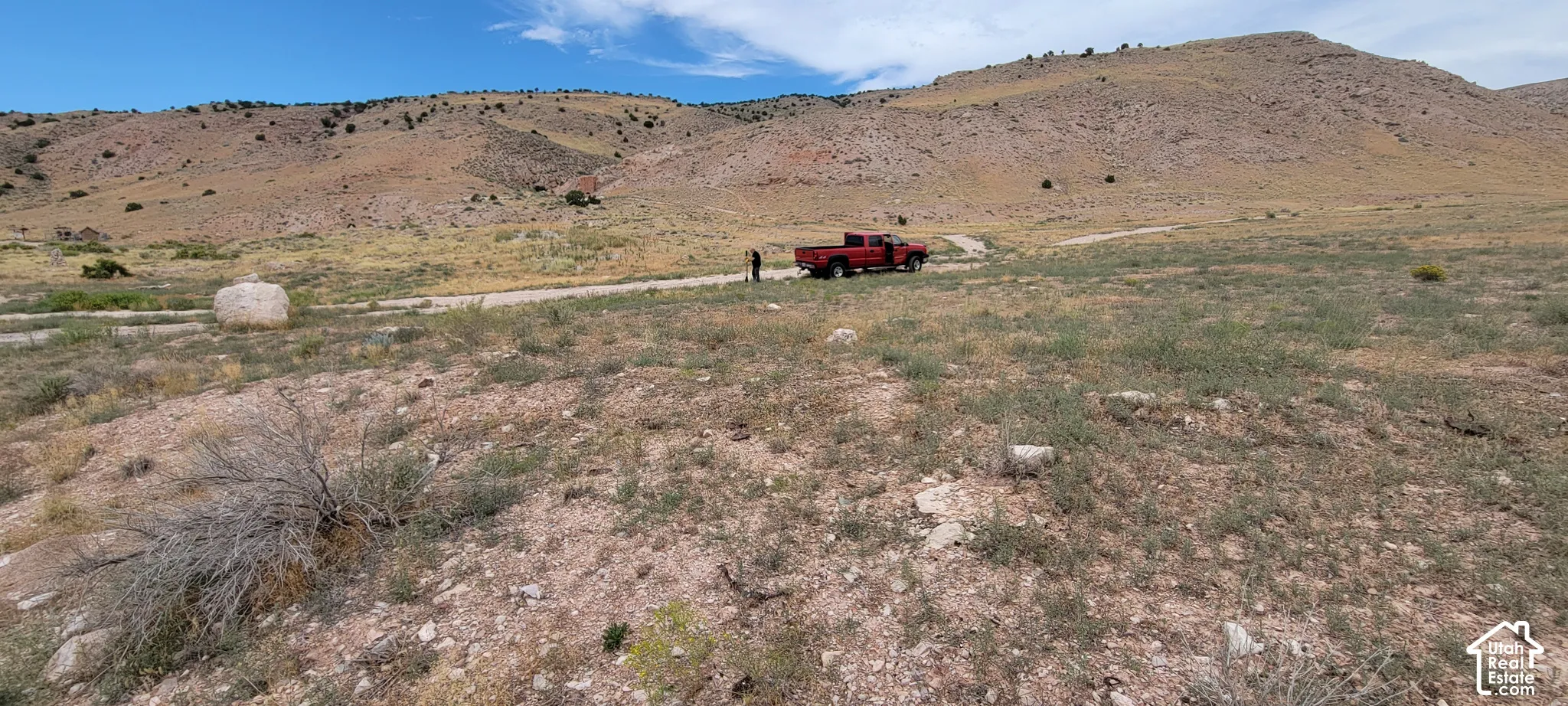 Expansive land parcel featuring natural terrain and distant hillsides