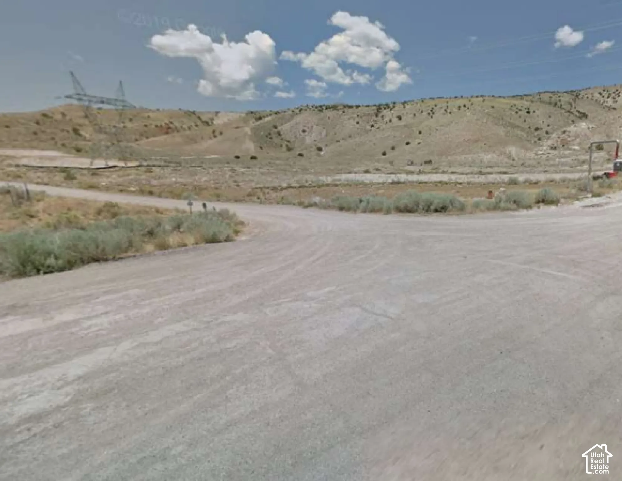 Expansive undeveloped land featuring rolling hills and natural desert vegetation