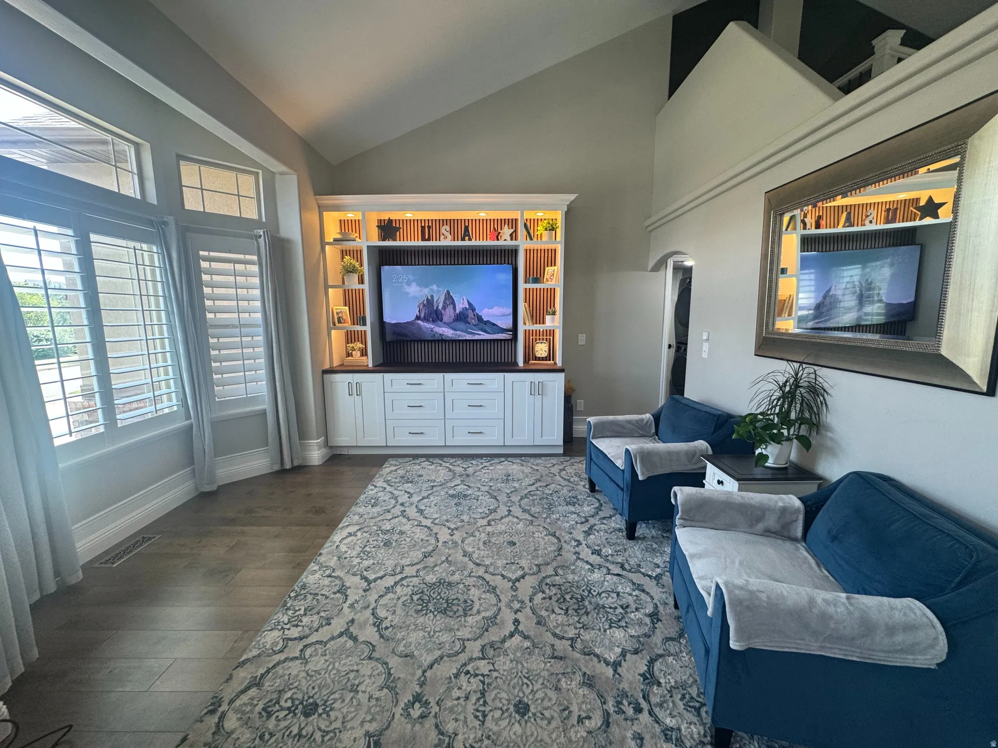 Living area featuring a brand new custom built-in entertainment center with integrated lighting and shelving